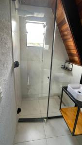 a bathroom with a shower and a sink at Pousada Estrela Dalva in Piracaia +19 photos