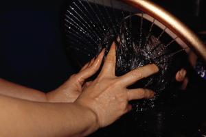 a person is holding a black racket at Oriental Suites Hotel & Spa in Hanoi