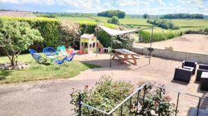 a backyard with a play area and a play house at Gite du moulin à la ferme pour 6 á 8 pers tt confort in Beauvilliers +19 photos