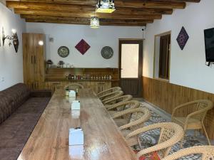 a large wooden table and chairs in a room at Nurata mountains Hayat guesthouse in Yukary-Ukhum