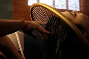 a woman is holding a whisk in her hair at Oriental Suites Hotel & Spa in Hanoi +48 photos