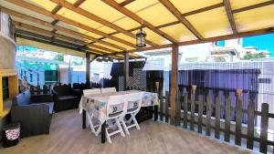 a patio with a table and chairs on a deck at Planta baja con piscina privada in Playas de Orihuela