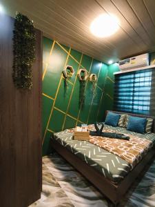 a bedroom with a green wall with skulls on it at Marcus Tiny House - Matcha in Cabanatuan City in Bangad