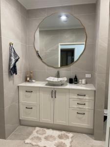 a bathroom with a sink and a mirror at Coastal Calm Seascapes Halls Head in Falcon +11 photos