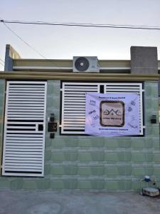 a building with a sign on the side of it at Marcus Tiny House - Matcha in Cabanatuan City in Bangad