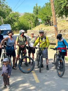 a group of people on bikes on a road at Nurata Eco Guesthouse in Yukary-Ukhum