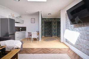 a living room with a kitchen and a dining room at Apartamenty Złotoryja Silver 2 in Złotoryja