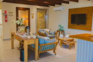 a living room with a couch and a table at Hotel VillaReal Charme in Guaratuba