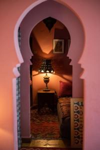 a room with a bedroom with a bed and a lamp at Dar Nour in Tangier