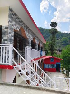 a building with stairs on the side of it at HIMALAYAN ESCAPE HOMESTAy in Sari