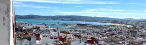 a view of a city and a body of water at Dar Nour in Tangier