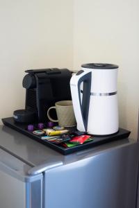 a table with a coffee maker and a coffee pot on it at Adam in Falasarna