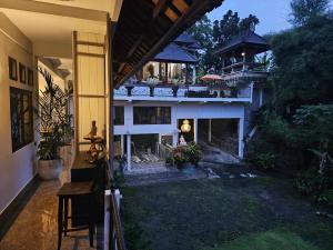 an outside view of a house with a fireplace at Villa by the River Samplangan in Gianyar