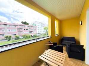 a room with a window and a couch and a table at Volcania Suites in Clermont-Ferrand