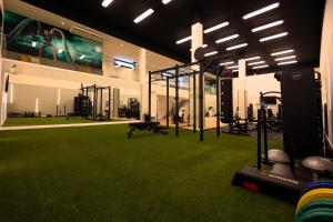 a room with a gym with green grass at Occidental Puerto Banús in Marbella
