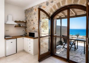 an open kitchen with a view of the ocean at Papanestoras Apartments in Kardamyli