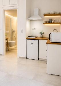 a white kitchen with a sink and a toilet at Papanestoras Apartments in Kardamyli +46 photos