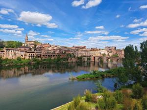 a view of a city with a bridge over a river at La-Vialette Chambres d Hôtes in Mont-Roc