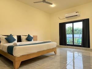 a bedroom with a large bed and a window at Sylvara Resort in Sasan Gir