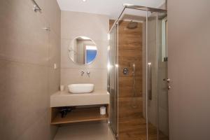 a bathroom with a sink and a shower at Adam in Falasarna