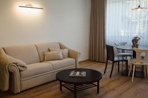 a living room with a couch and a table at Aparthaus Vergissmeinnicht in Söll
