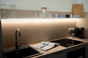 a kitchen with a sink and a counter with a sink at Aparthaus Vergissmeinnicht in Söll +39 photos