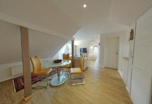 a living room with a table and yellow chairs at Landhaus Dreesen in Timmendorfer Strand