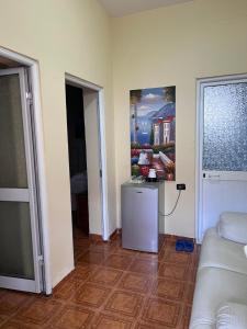 a living room with a couch and a painting on the wall at Vila Beliz in Tirana