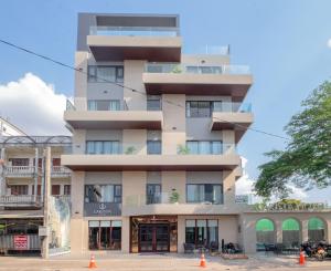 an apartment building with balconies and orange cones at Carista Hotel in Vientiane