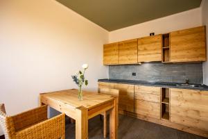 a kitchen with wooden cabinets and a wooden table at Chalet Bellavista in Spiazzi Di Caprino