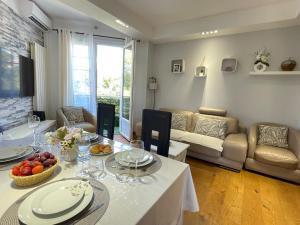a living room with a table with food on it at Bella Stay in Cannes
