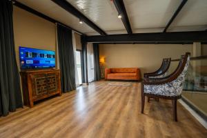 a living room with a couch and a television at FortuNorth in Skardu
