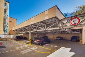 a parking lot with cars parked in front of a building at Wenceslas Hotel & Apartments in Prague +31 photos