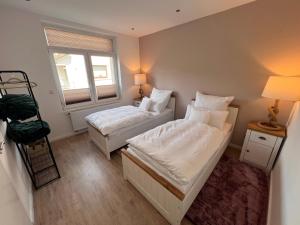 a small bedroom with two beds and a window at Güden Pearl Bhaven Deck 6 ,Exklusive große Wohnung,Hochwertige Ausstattung,Privatparkplatz & Carport,Großer Garten mit Gartenhaus,Langzeitaufenthalt in Bremerhaven