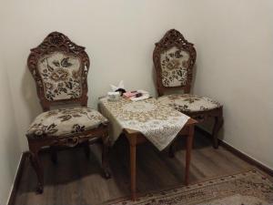 two chairs and a table and a table and chairs with a table and chairs at KING City Center Hostel in Baku +48 photos