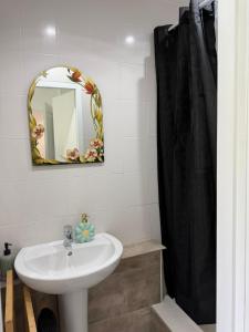 a bathroom with a sink and a mirror at Appartement refait dans ancien hôtel restaurant in Saint-Uze