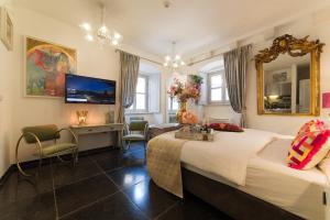 a hotel room with a bed and a mirror at Prijeko Palace in Dubrovnik