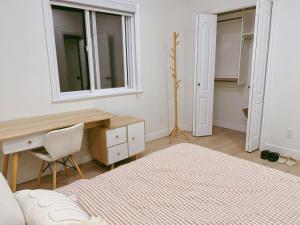 a bedroom with a bed and a desk and a mirror at Comfortable 1BR Retreat, Private Entry in Richmond