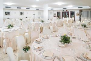 a banquet hall with white tables and chairs at Hotel Sa Pedra in Murta Maria +236 photos