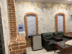 a room with two arched windows and a waiting room at Hayatt Palace Sukkur in Sukkur