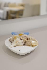 a plate of food on a counter with a plate of food at Joel Family Apartment's Golem Center in Golem