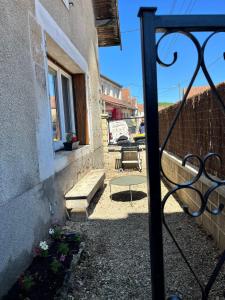 a gate to a building with a bench and a window at Maison de Village in Leuglay
