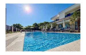a large swimming pool in front of a building at Amazing Home In Imotski With Sauna in Imotski