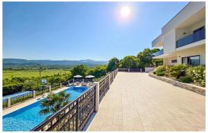 a balcony of a house with a swimming pool at Amazing Home In Imotski With Sauna in Imotski +51 photos