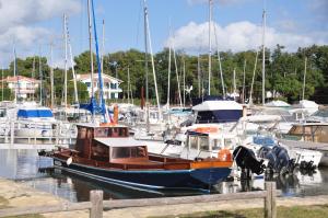 a boat docked in a marina with other boats at Le Marsalat - Lanton in Lanton