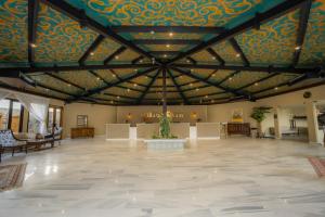 a large lobby with a ceiling with a patterned ceiling at FortuNorth in Skardu +55 photos