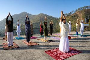 a group of people doing yoga on mats at Aranya Tara in Bhīm Tāl