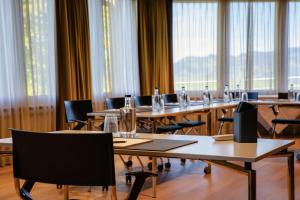 a conference room with tables and chairs and windows at Wellness Hotel Stoos in Stoos +88 photos
