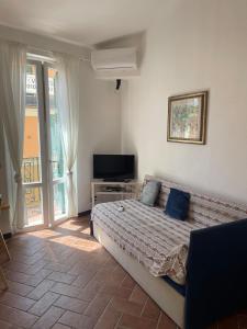 a bedroom with a bed and a tv and a window at luca in Vernazza