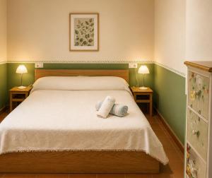 a bedroom with a bed with two towels on it at Ca la Genoveva in Montsonis +20 photos